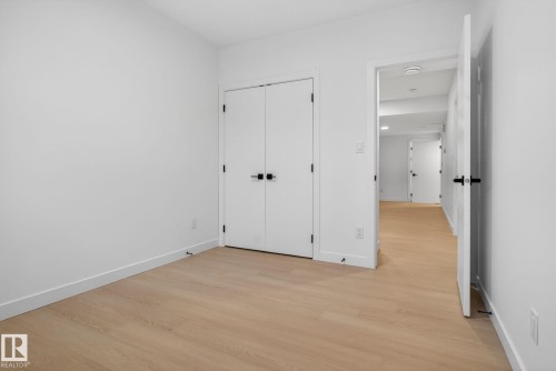 Light wood-finish flooring complements crisp white walls - 105 Wyatt Ridge, Fort Saskatchewan, AB 