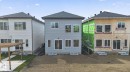 Gray vinyl-sided exterior featuring multiple windows and sliding glass doors - 105 Wyatt Ridge, Fort Saskatchewan, AB 