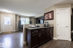 Dark wood-finish flooring throughout the main level - 