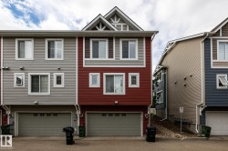 Red-sided townhome featuring a two-story elevation with a prominent front-facing gable - 
