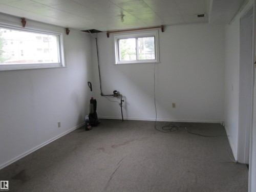 White painted walls with two windows providing natural illumination - 8122 83 Avenue, Edmonton, AB 