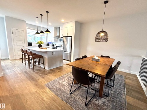 Open-concept kitchen and dining area featuring light wood-finish flooring - 5281 Edgemont Boulevard, Edmonton, AB 