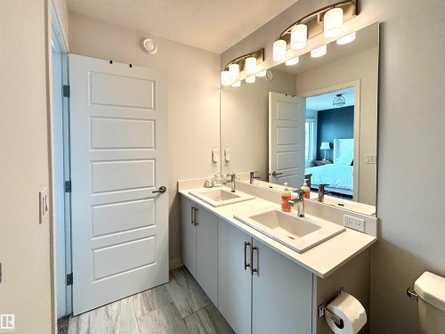 Dual vanity with undermount sinks and light-toned countertops - 5281 Edgemont Boulevard, Edmonton, AB 