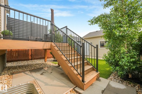 Wood-finish elevated deck with black metal railings and privacy screening - 5281 Edgemont Boulevard Nw, Edmonton, AB - Outdoor With Deck Patio Veranda With Exterior