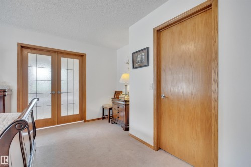 Double French doors with frosted glass panels and a solid wood door - 16512 87 Street, Edmonton, AB 