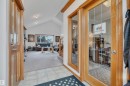 Entryway featuring tile flooring, wood-finish trim, and a glass-paneled door - 16512 87 Street, Edmonton, AB 