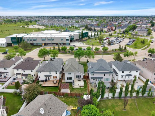 Aerial view showcasing the property's proximity to a contemporary school building with a large parking area - 16512 87 Street, Edmonton, AB 