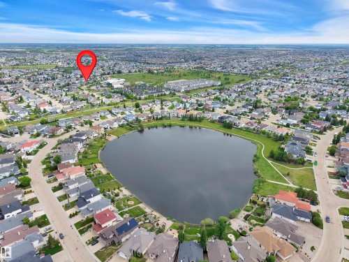 Aerial perspective showcasing a residential area with a prominent central lake - 16512 87 Street, Edmonton, AB 