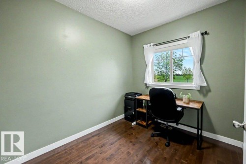 Room with wood-finish flooring, light green walls, and white baseboards - 13004 164 Avenue, Edmonton, AB 