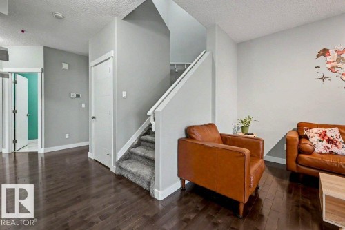 Spacious interior featuring dark wood-finish flooring throughout the main level - 13004 164 Avenue, Edmonton, AB 