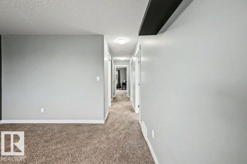 Hallway with recessed lighting, light gray wall paint, and white trim - 13004 164 Avenue, Edmonton, AB 