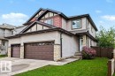 Multi-level exterior featuring light-colored siding, dark trim, and decorative stone accents - 13004 164 Avenue, Edmonton, AB 