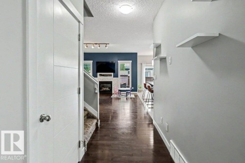 Dark wood-finish flooring extending from the entryway into the living area - 13004 164 Avenue, Edmonton, AB 