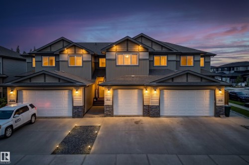 Multi-unit residential structure featuring attached garages with sectional doors - 311 Genesis Vi, Stony Plain, AB 