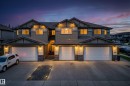 Multi-unit residential structure featuring attached garages with sectional doors - 311 Genesis Vi, Stony Plain, AB 