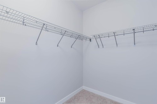 Spacious closet featuring white walls, wire shelving, and carpeting - 2921 Anderson Crest, Edmonton, AB 