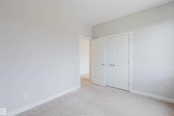 Neutral tone walls with white trim, light-colored carpet, and paneled double doors - 