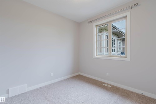 Neutral-toned room with light gray walls and plush carpet flooring - 2921 Anderson Crest, Edmonton, AB 