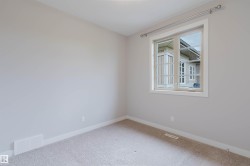 Neutral-toned room with light gray walls and plush carpet flooring - 