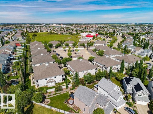 Expansive aerial perspective showcasing a residential neighborhood with numerous detached homes and multi-family buildings - 71 3040 Spence Wynd, Edmonton, AB 