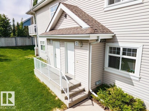 Exterior featuring horizontal siding, white trim, and a shingled roof - 71 3040 Spence Wynd, Edmonton, AB 