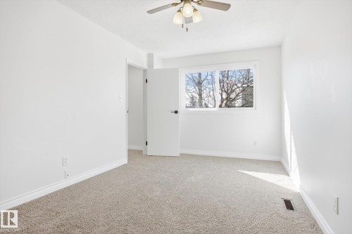 Bright interior space featuring light-colored carpeting and white walls - 857 Erin Place, Edmonton, AB 