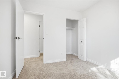 Neutral-toned carpet flooring and white walls define this interior space - 857 Erin Place, Edmonton, AB 