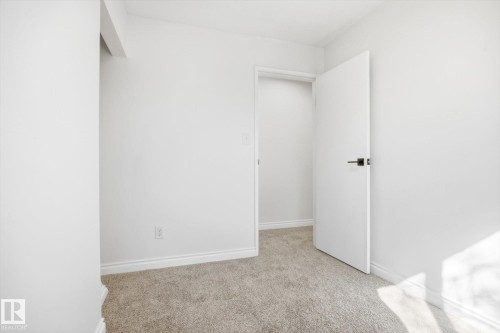 Neutral-toned carpet flooring with white baseboards throughout - 857 Erin Place, Edmonton, AB 