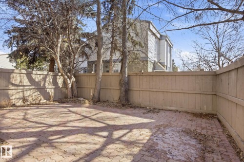 Patio area featuring interlocking paver stones, surrounded by a panel fence - 857 Erin Place, Edmonton, AB 