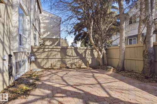 Paved patio area featuring interlocking brick, bordered by a privacy fence - 857 Erin Place, Edmonton, AB 
