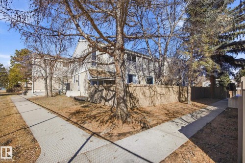 Multi-level residential building featuring light-colored siding and a covered entry - 857 Erin Place, Edmonton, AB 