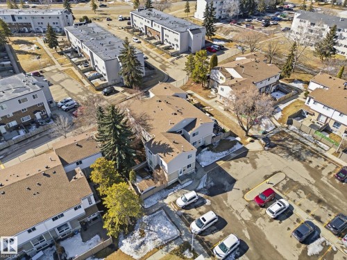 Aerial perspective showcasing a multi-unit residential property with brown shingle roofing and light-colored siding - 857 Erin Place, Edmonton, AB 