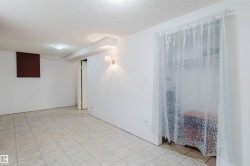 Finished room featuring neutral wall paint, tile flooring, and a flush-mount ceiling light - 