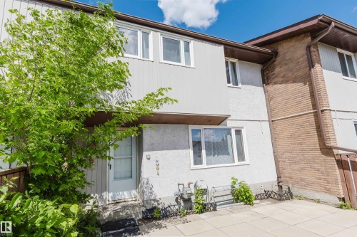 Multi-level exterior featuring white vertical siding and stucco finishes - 4 14310 80 Street, Edmonton, AB 
