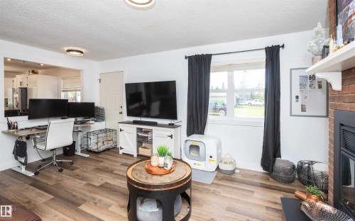 Living area with wood-finish flooring and white walls - 10232 101 Street, Westlock, AB 