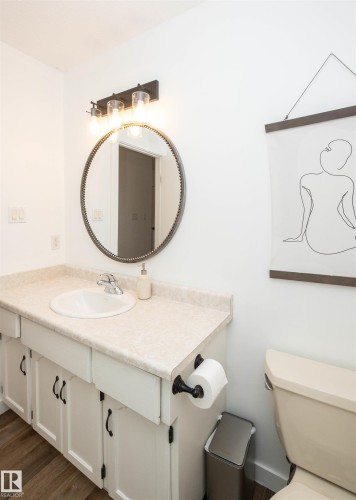 Vanity with a white basin and chrome faucet, set against a speckled countertop - 10232 101 Street, Westlock, AB 