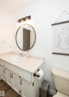 Vanity with a white basin and chrome faucet, set against a speckled countertop - 
