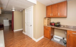 Warm wood-finish flooring extends throughout this versatile space - 