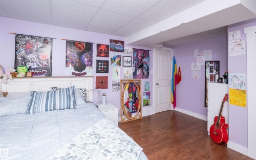 Lavender-painted room with wood-finish flooring - 10232 101 Street, Westlock, AB 