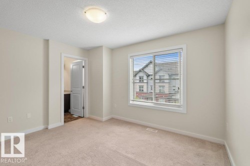 Expansive room featuring neutral-toned carpeting and light-colored walls - 125 655 Watt Boulevard, Edmonton, AB 