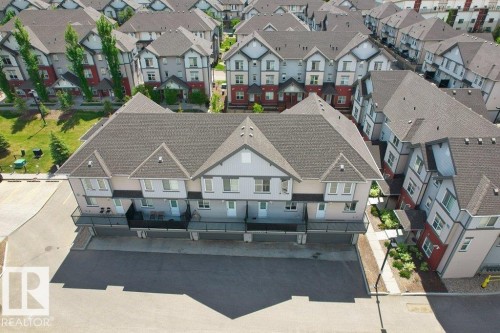 Contemporary townhome development featuring multiple units with individual balconies and dedicated parking areas - 125 655 Watt Boulevard, Edmonton, AB 