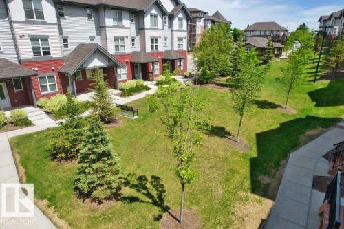 Multi-level residential buildings featuring red and gray siding - 125 655 Watt Boulevard, Edmonton, AB 