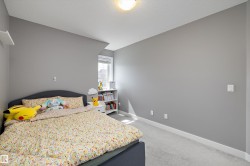 Bedroom featuring a window, carpet flooring, a ceiling-mounted light fixture, and white baseboards - 