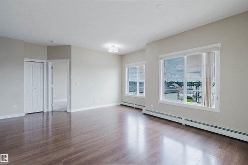 Spacious interior with rich wood-finish flooring - 402 3670 139 Avenue, Edmonton, AB 