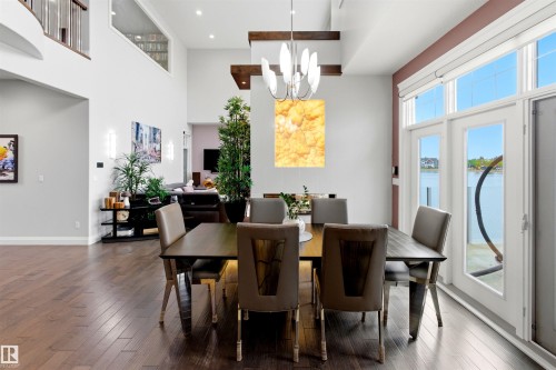 Dining area featuring wood-finish flooring and direct access to exterior through French doors - 9003 16 Avenue, Edmonton, AB 