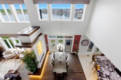 Two-story living area with abundant natural light from multiple windows - 