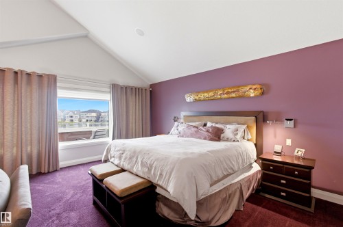 Vaulted ceilings define this space, complemented by a large window overlooking the water - 9003 16 Avenue, Edmonton, AB 