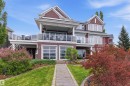 Multi-level residence featuring a stone-clad walkway, manicured lawn, and mature landscaping - 9003 16 Avenue, Edmonton, AB 