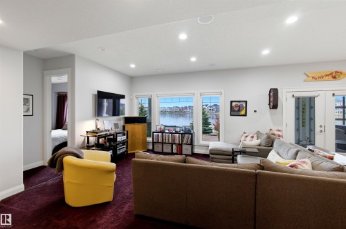 Living area featuring a textured maroon carpet and recessed lighting - 9003 16 Avenue, Edmonton, AB 
