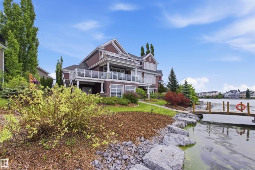 Multi-level residence featuring a lakeside setting with a private wooden dock - 9003 16 Avenue, Edmonton, AB 